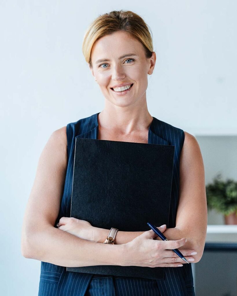 Happy adult businesswoman holding folder and penci 8683LMF.jpg